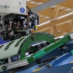 A fuselage structure is clamped on the component carrier and is being processed by the cpac.