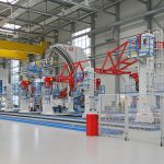 Integrated assembly jigs in an assembly line for a more efficient manufacturing environment.