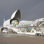 Loading a cargo aircraft with a partially assembled aircraft.